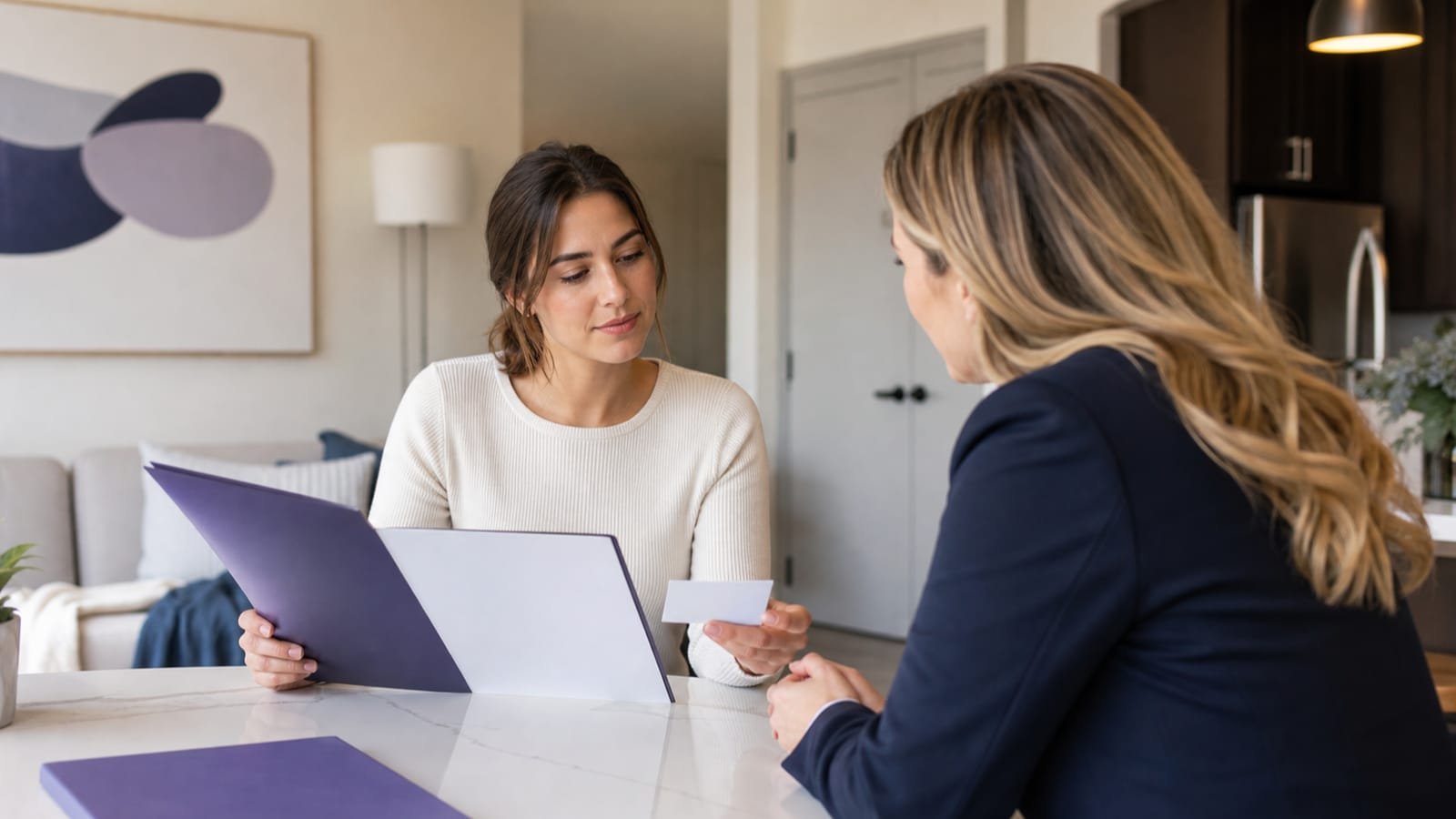 Renter and property manager calmly review lease and coverage folders.